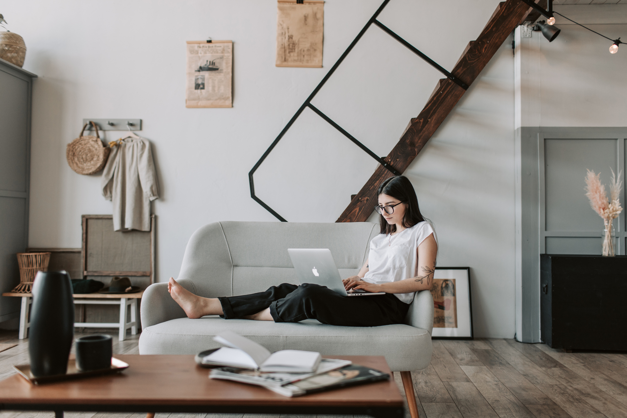 Content young woman using laptop in modern living room